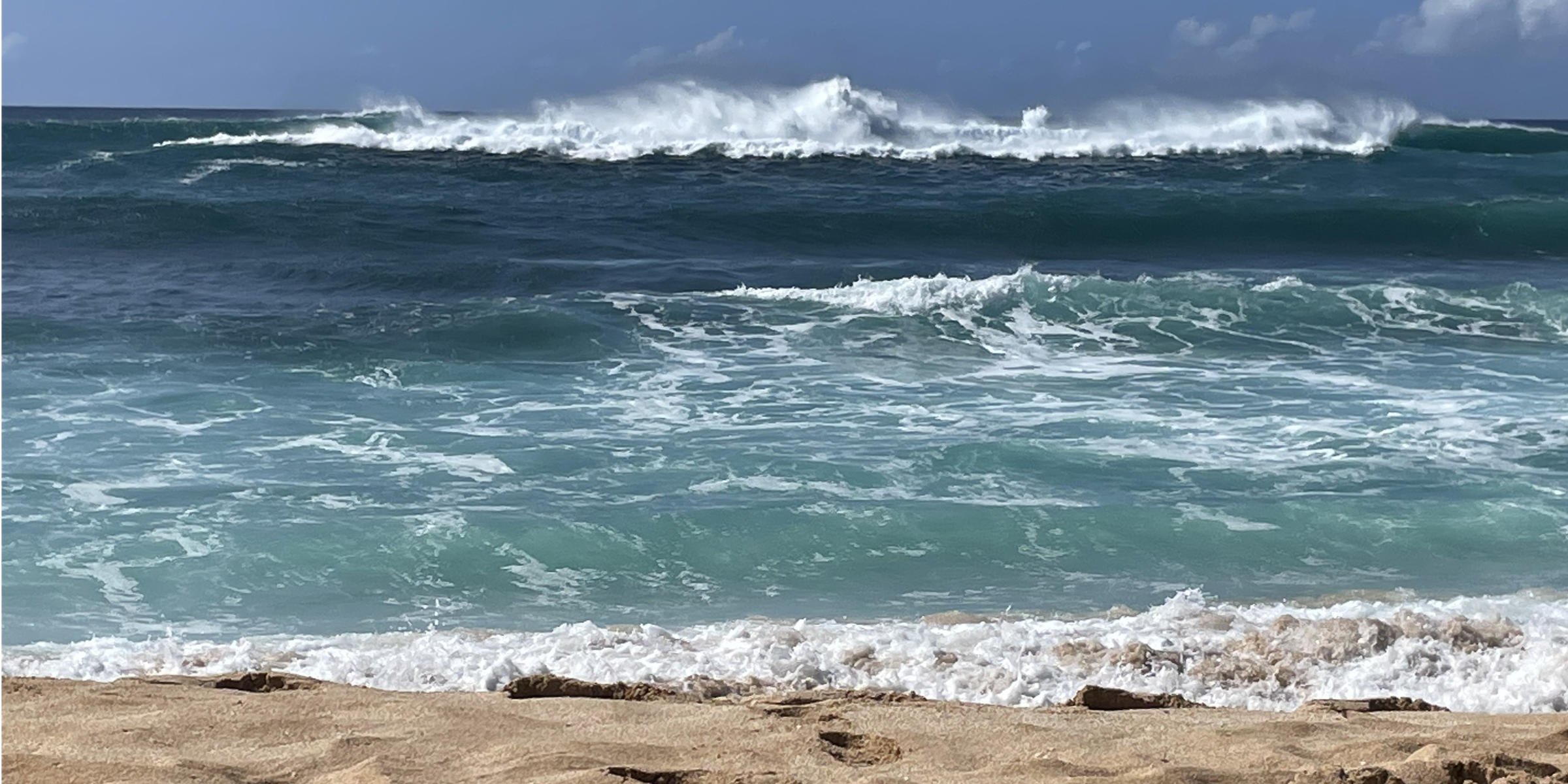 Ocean waves breaking on a sandy shore